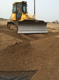 Automated doser blades gravel over geotextile cloth for road construction project  Saskatoon Saskatchewan completed by Rite Choice Construction